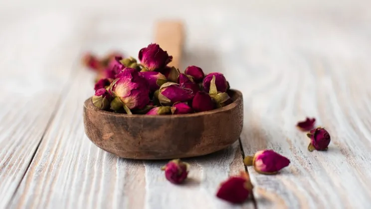 Red clover extract in a wooden bowl, natural herbal ingredient for circulation support.